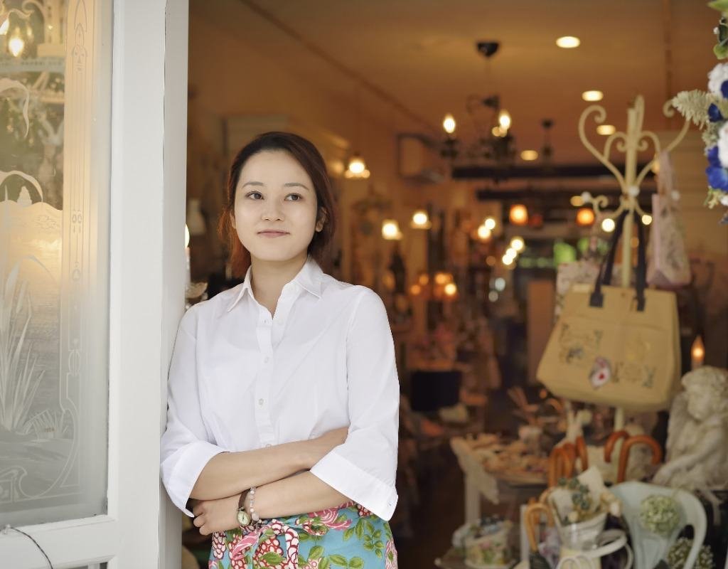 Shop owner standing in the doorway of her store